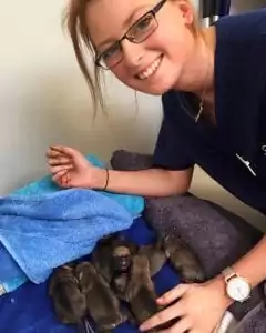 Sarah Mason with puppies