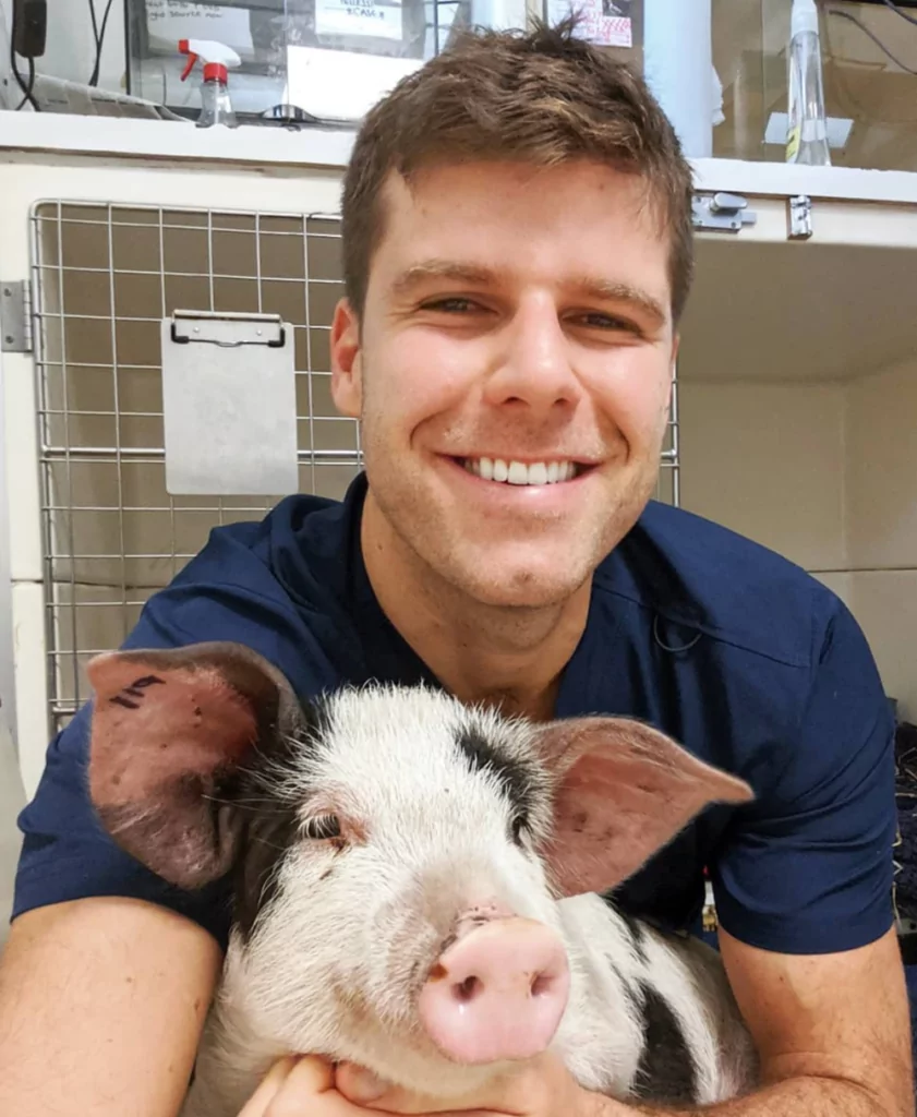 Michael Lazaris with a pet pig