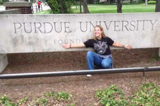 Natasha Feduik in front of the sign of Purdue University - I Love Veterinary