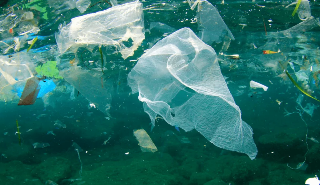 plastic pollution floating underwater in the ocean